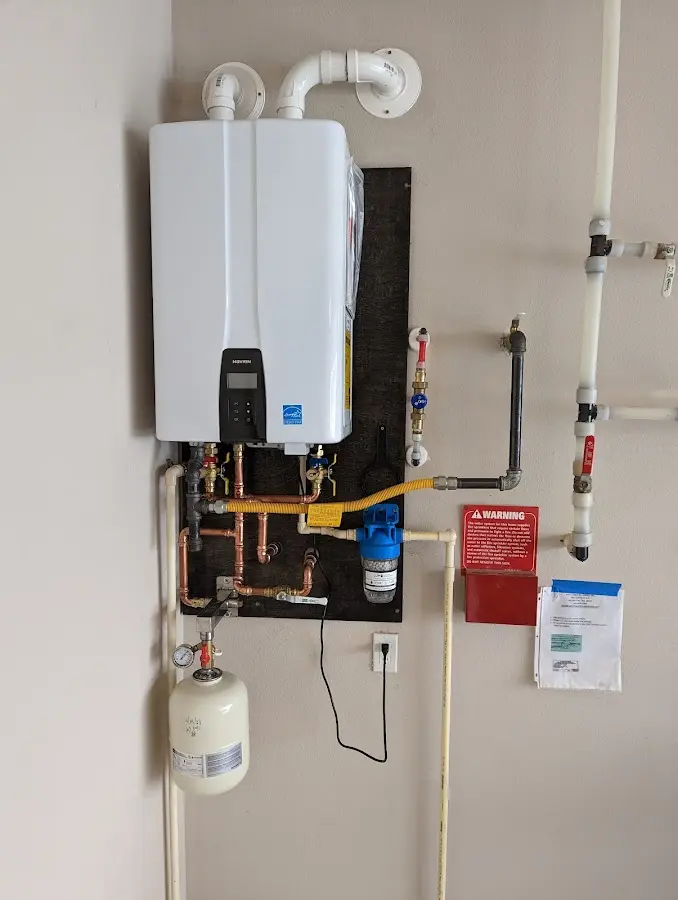 Professional plumber installing copper piping in a Paupack home